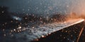 Raindrops splashing on a dark surface during golden hour, creating shimmering light particles and abstract patterns Royalty Free Stock Photo