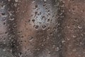 Raindrops on the surface of a dirty window glass