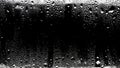 Raindrops on the surface of the window panes with a black background. Natural rain pattern on the glass. Light Royalty Free Stock Photo