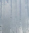 Raindrops and Water Runs on a Glass Window Pane
