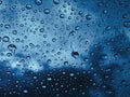 Raindrops water on the window glass against the dark clouds