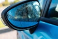 raindrops on the wet side-view mirror. rainy weather and car wash