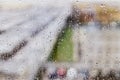 Raindrops on window background. Water droplets on glass surface. Rainy weather. Rain drops on background of city buildings. Rainy Royalty Free Stock Photo