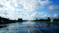 Raindrops on a window with a blurred view of a wet street Royalty Free Stock Photo