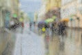 Raindrops on window glass, unrecognizable people walk on road in rainy day. View from the window on city street, blurred Royalty Free Stock Photo