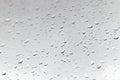 Raindrops on a window glass in rainy cloudy day against a gray sky. Autumn, depressive, rainy weather Royalty Free Stock Photo