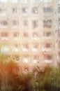 Raindrops on window glass, rainy day, looking trough window in the light of the setting sun. Vertical photography Royalty Free Stock Photo