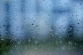 Raindrops on a window glass on a rainy day. Rain, cloudy day, sadness, longing, depression concept Royalty Free Stock Photo