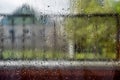 Raindrops on window pane. Blurred background outside the window in the rain Royalty Free Stock Photo