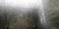 Rain droplets on a window glass pane with dark stormy clouds in the background Royalty Free Stock Photo