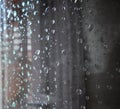 Raindrops on a window pane. Drops of water on a metal surface, on a window pane, Window in a house in rainy time Royalty Free Stock Photo