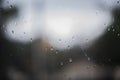 raindrops on a window. Rainy window at night. dark blue wet, drops of water rain on glass background. concept of autumn weather Royalty Free Stock Photo