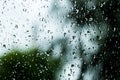 Raindrops on a window. Rainy window at night. Drops on the black glass. dark blue wet, drops of water rain on glass background. co Royalty Free Stock Photo