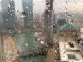 Raindrops on window surface reflect upside down images of Chicago River cityscape