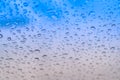 Raindrops on the window. Water droplets on glass. Blue tone Royalty Free Stock Photo