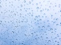 The raindrops on the windscreen or windshield or car glass. View from the inside of the car with a grey sky background. Adjust the Royalty Free Stock Photo