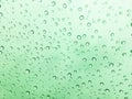 The raindrops on the windscreen or windshield or car glass. View from the inside of the car with a grey sky background. Adjust the Royalty Free Stock Photo