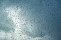 Raindrops on the windshield; in the background dark sky and a break in the clouds, California Royalty Free Stock Photo