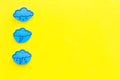 Rainfall forecast concept. Weather icons. Rainy cloud, lightening on yellow background top view copy space