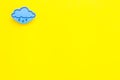 Rainfall forecast concept. Weather icons. Rainy cloud on yellow background top view copy space