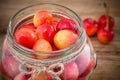 Rainier Cherries in glass on wooden background Royalty Free Stock Photo