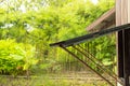 Raining window open, using bamboo poles to prop