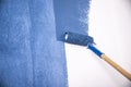 Raint roller with blue paint Royalty Free Stock Photo