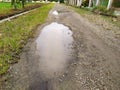 rainwater that pools on the potholed road Royalty Free Stock Photo