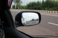 Car side mirror with rain drops on car window on white cloud background