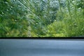 Rainy abstract frame and water droplet pattern on glass window. View from the car interior