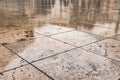 Rainy autumn brown street tile outdoor floor wet surface abstract people silhouette reflection Royalty Free Stock Photo