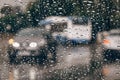 Rainy city background. Moving cars and bus seen from raindrop-covered window of passing car. Raindrops on window glass Royalty Free Stock Photo