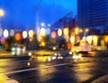 Rainy city blurred light at night modern building and wet asphalt colorful light reflection night cars traffic urban lifestyle b