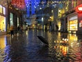 Rainy City Christmas Tallinn Old town street night light people walking with umbrellas rain drops reflection on window