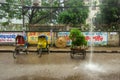 A rainy city street & motion of rickshaw