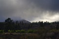 Rainy clouds floating very low to meadow in mountains Royalty Free Stock Photo