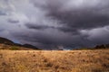 Rainy clouds over a field. Royalty Free Stock Photo