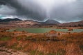 Rainy clouds over a green lagoon. Royalty Free Stock Photo