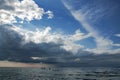 Rainy dark clouds during at sunset at Baltic sea.