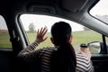 Rainy Day or Bad Weather in a Vacation Concept. a Sadness Woman with Hot Coffee sitting in Car and Looking Outside, Waiting for Royalty Free Stock Photo