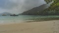 Rainy day on the beach. The sky is cloudy, the mountains are hidden in fog.