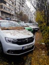 Rainy day in Bucharest. Autumn leaves on a parked car in downtown Bucharest, Romania, 2019