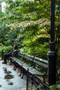 Rainy day in central park, New York, Man on wet bench looking far away Royalty Free Stock Photo