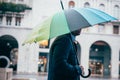 Rainy day in the city and businessman holding umbrella Royalty Free Stock Photo