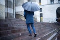 Man walking in the city with umbrella on rainy day Royalty Free Stock Photo