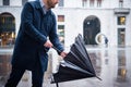 Rainy day in the city and businessman opening umbrella Royalty Free Stock Photo