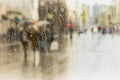 Rainy day in city. Silhouette of people with umbrella seen through raindrops on glass of window . Selective focus on the Royalty Free Stock Photo