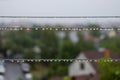 Rainy day, drops on clothes washing lines Royalty Free Stock Photo