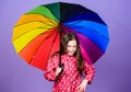Rainy day fun. Happy walk under umbrella. Enjoy rain concept. Fall season. Kid girl happy hold colorful rainbow umbrella