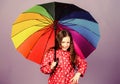 Rainy day fun. Happy walk under umbrella. Enjoy rain concept. Fall season. Kid girl happy hold colorful rainbow umbrella